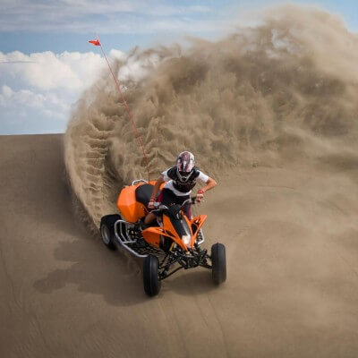Man on ATV in sand dunes